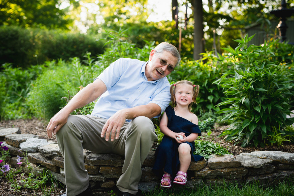 toddler sitting for photo with Grandpa